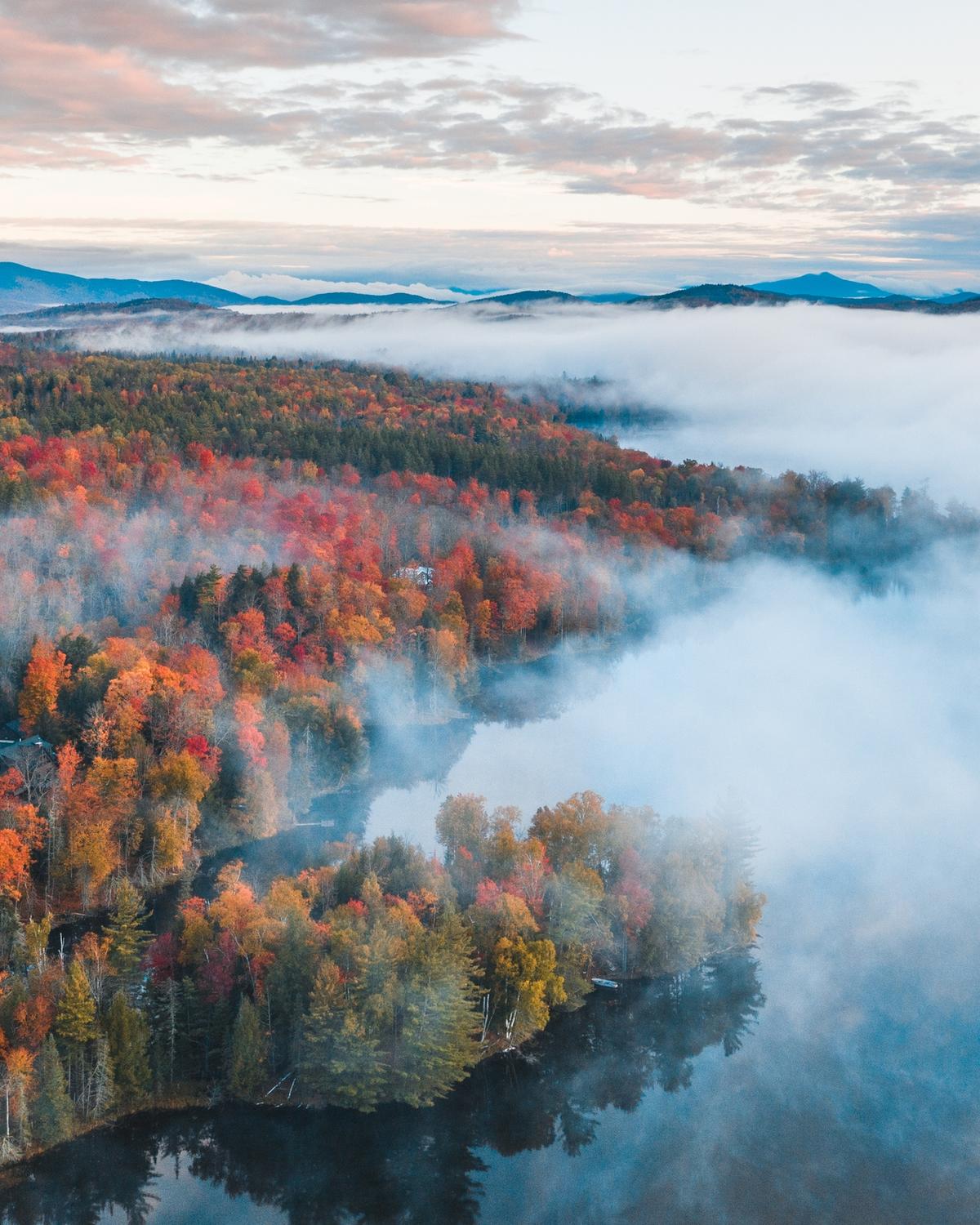 Low fog over Autumn folliage near a lake